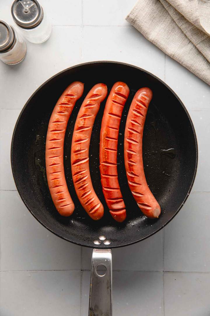 Making of Hot Dog with Sauerkraut and Onion Jam